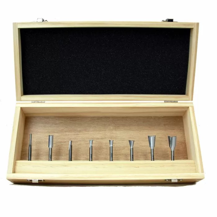 Woodworking router bit set in a wooden storage box on white background