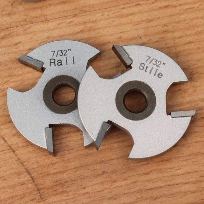 7/32 inch rail and stile woodworking cutter blades on a wooden surface