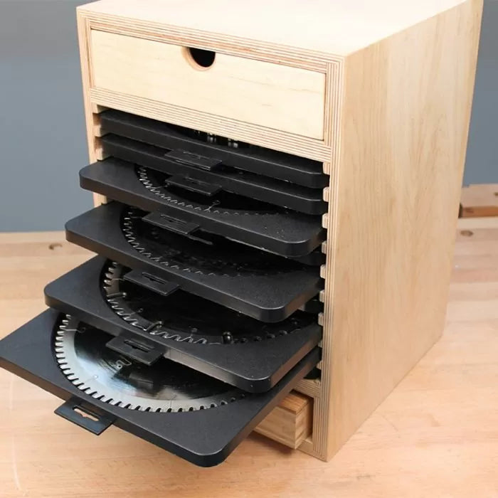 Wooden saw blade storage box with multiple pull-out trays holding circular saw blades