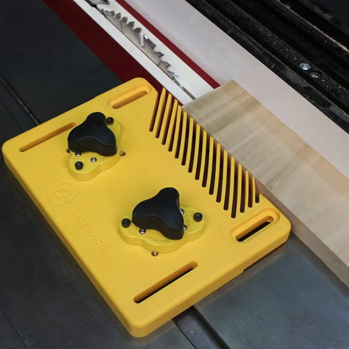 Table saw featherboard holding wood against fence for safe, precise woodworking cut