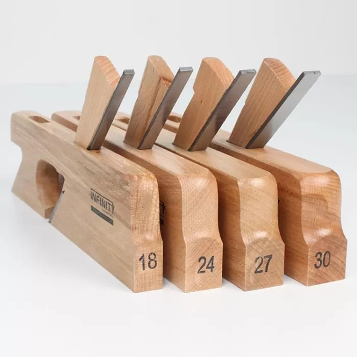 Set of four wooden woodworking hand planes with labeled sizes and exposed steel blades.