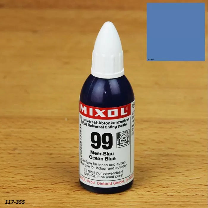 Mixol universal tinting paste bottle, 99 Ocean Blue color, on a wood surface with color swatch
