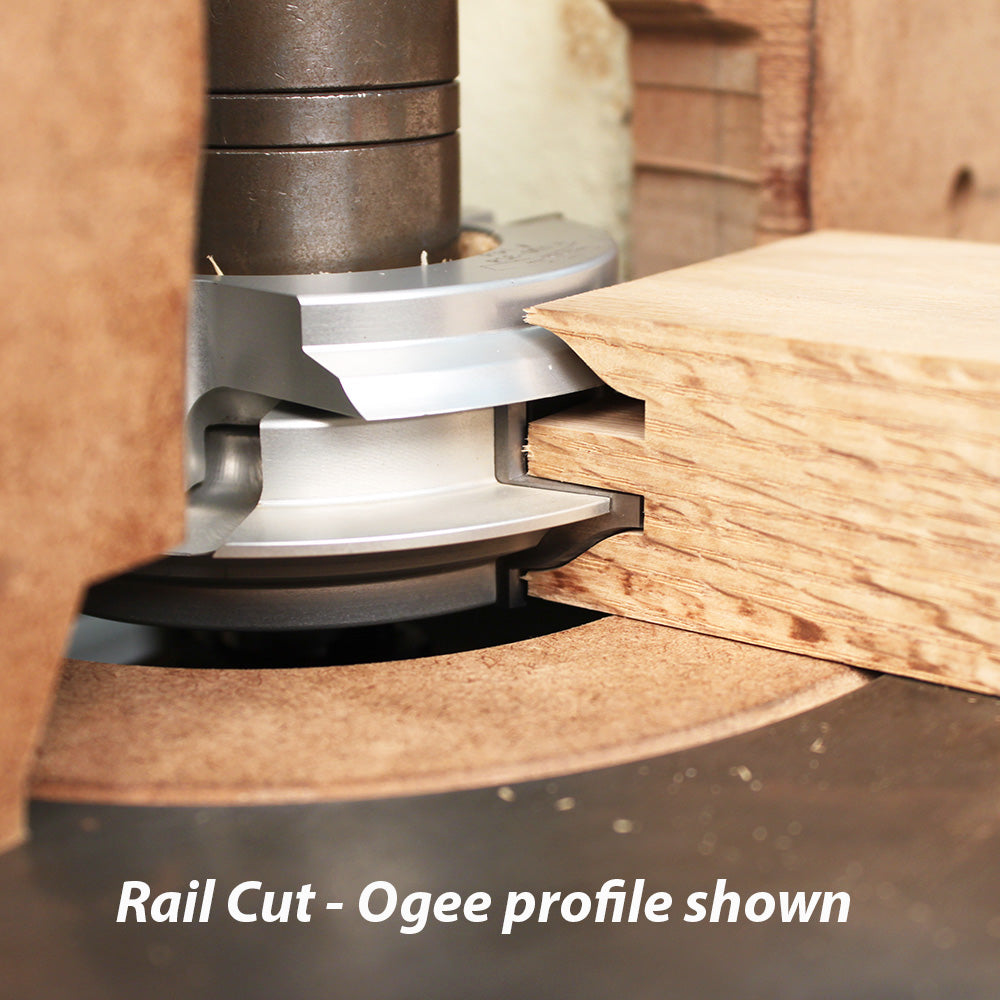 Router bit cutting ogee rail profile in hardwood for woodworking joinery.