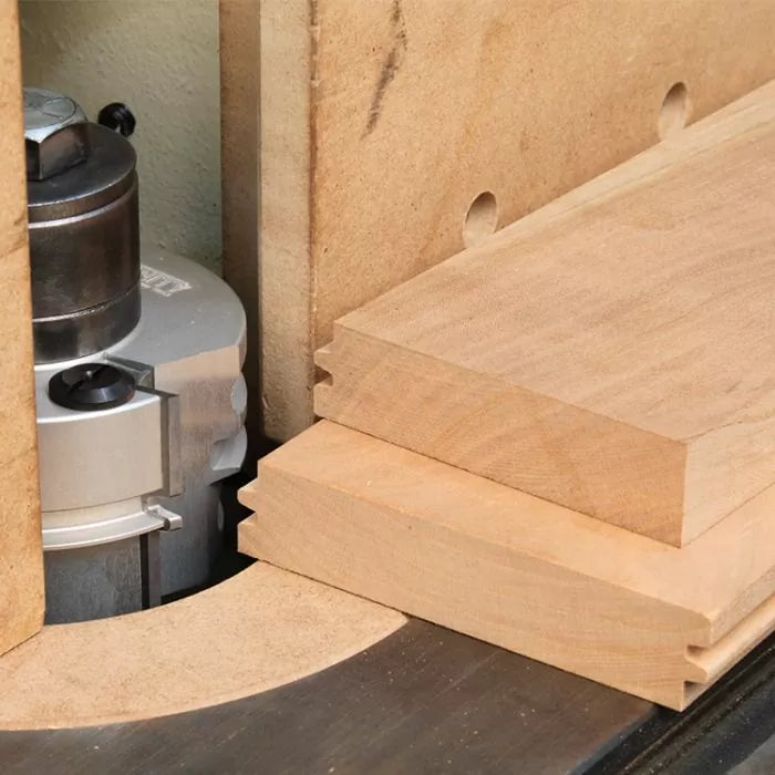 Router table with stacked wood boards showing tongue and groove joinery