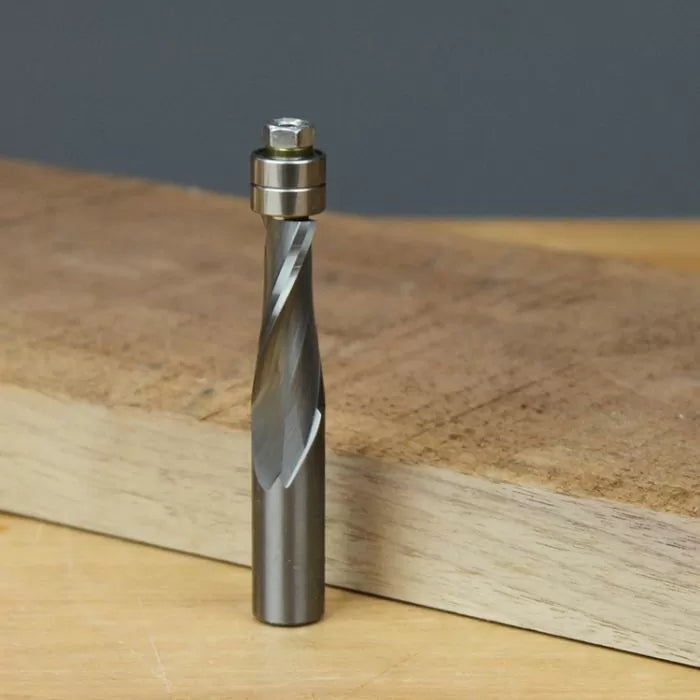 Carbide spiral flush trim router bit with bearing on wood surface for woodworking