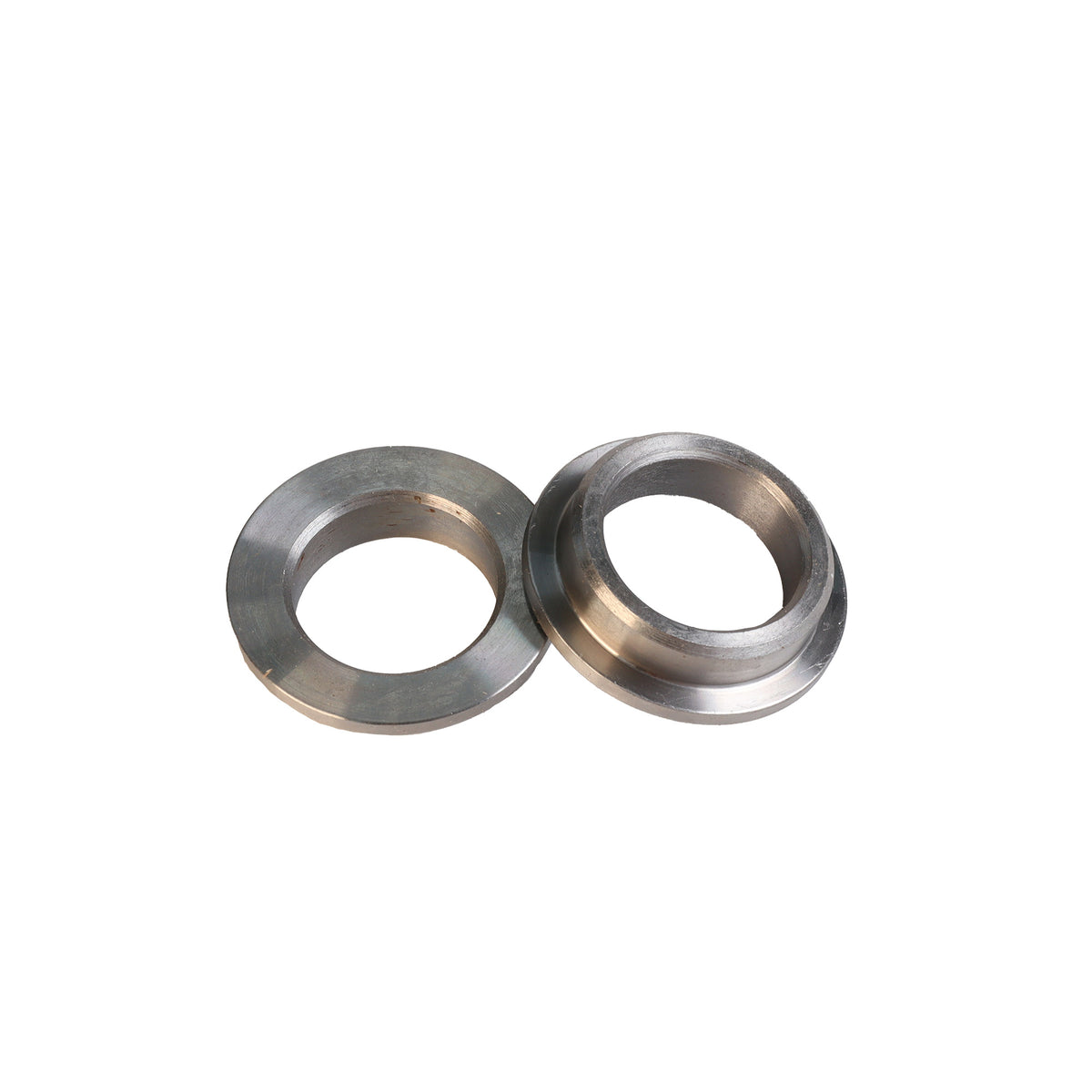 Pair of metal router table flange bushings for woodworking tools on white background