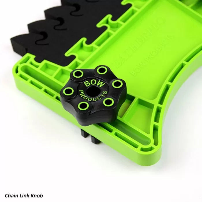 Close-up of a chain link knob for woodworking jigs, black and green with ergonomic grip.