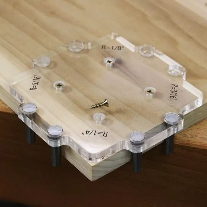 Acrylic corner radius jig for woodworking on a wood board, with labeled radius sizes.