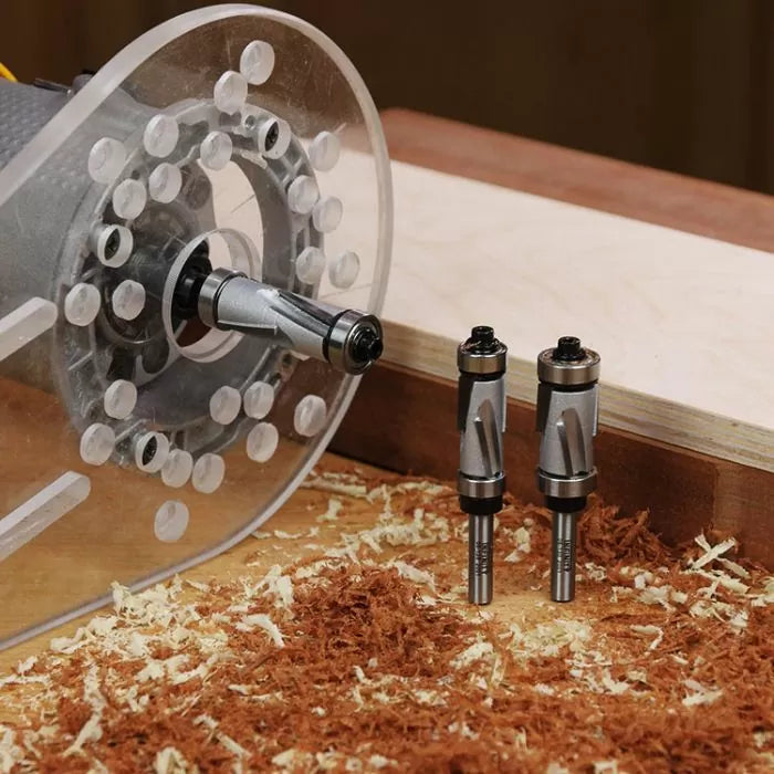 Wood router with two straight router bits on workbench with wood shavings and lumber