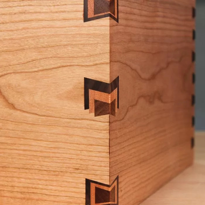 Close-up of decorative dovetail box joint in contrasting hardwood for woodworking projects