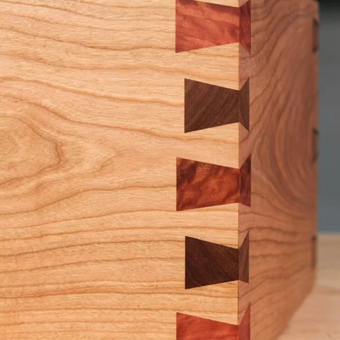 Close-up of wooden box corner with contrasting dovetail joinery detail