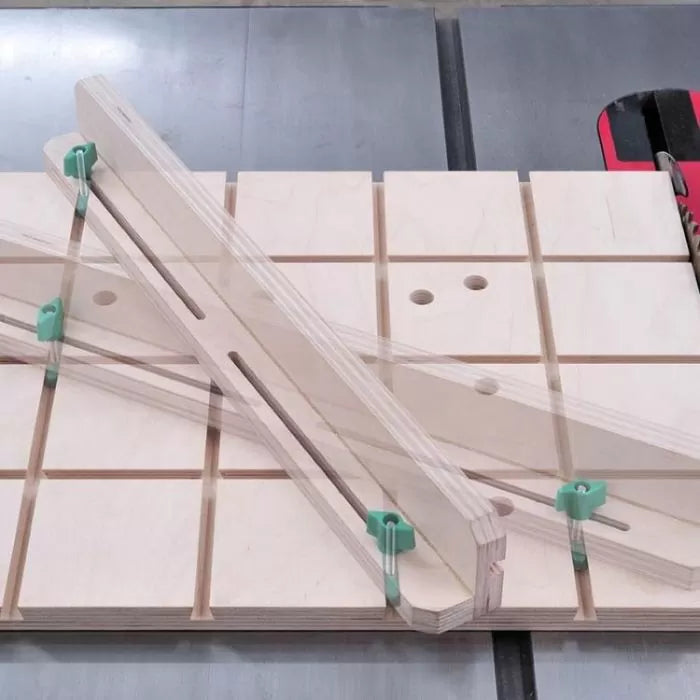 Woodworking table saw sled with adjustable clear acrylic fence and green clamps