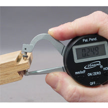 iGaging digital thickness gauge measuring the edge of a wood board