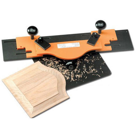 Orange cabinet door router template on a jig base with a shaped wooden door panel