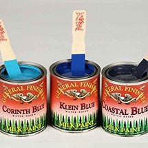 Three cans of General Finishes milk paint in Corinth, Klein and Coastal Blue