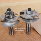 Two silver rail and stile router bits for woodworking on a wooden surface.