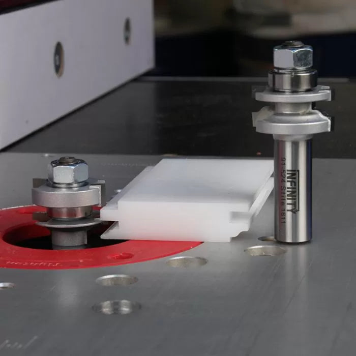 Router table setup with slot cutter router bits and plastic jig for woodworking