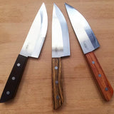 Set of three chef knives with different wood handles on a wooden surface, sharp steel blades