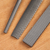 comparison photo of a round, half round, and flat rasp.