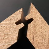 Close-up of two wood pieces joined with a precise lock miter joint for woodworking projects