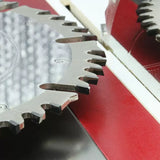 Close-up of carbide-tipped table saw blade in woodworking setup
