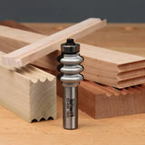 Roundover edge router bit with sample molded wood pieces on a workbench, woodworking tool