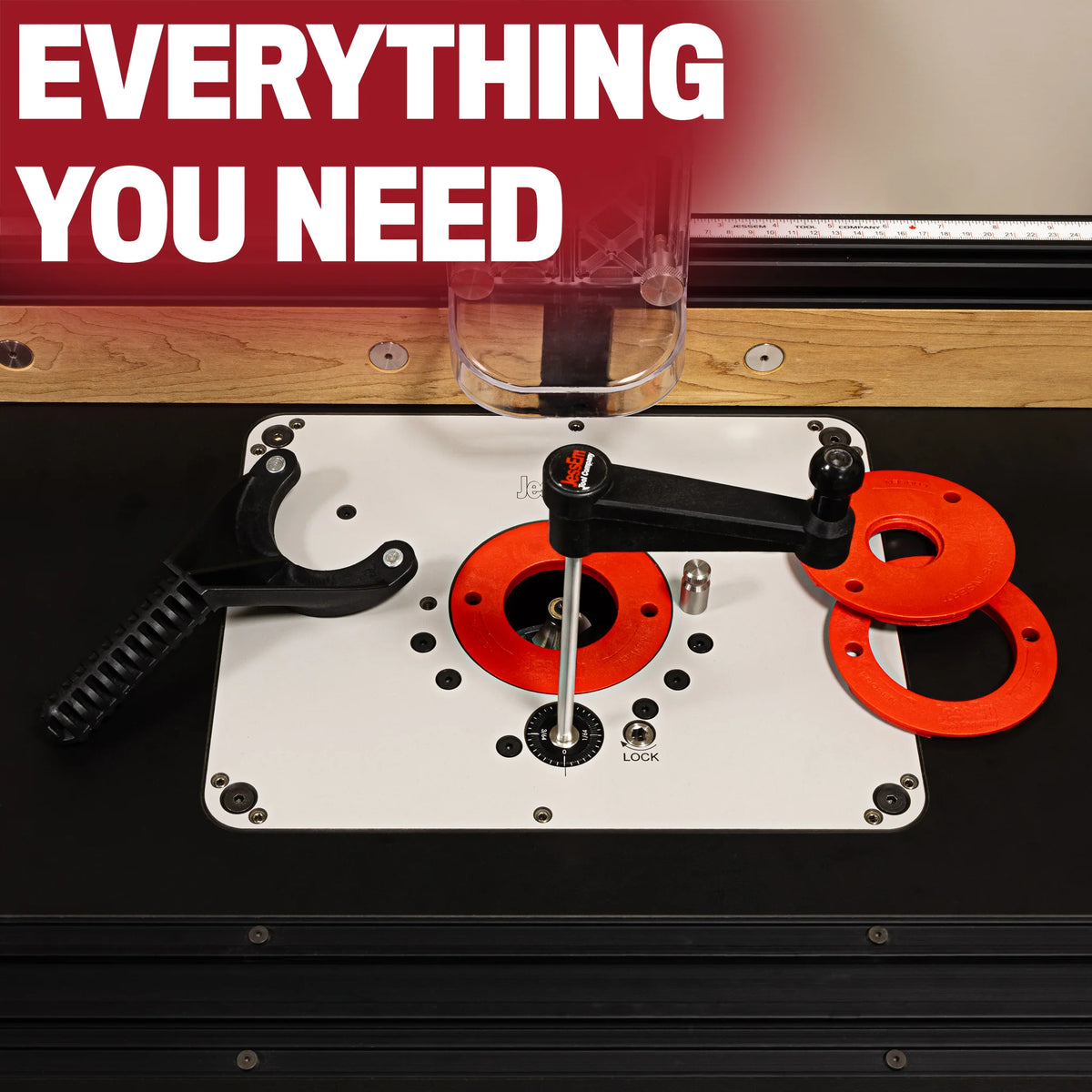 Router table insert plate with accessories, adjustable fence, and red rings for woodworking.