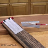 Incra 6-inch rule set with precision woodworking rulers and marking pencil on a workbench