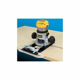Woodworking router with edge guide attached to a work table for precision cutting