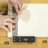 Woodworker using a JessEm precision marking tool and ruler to scribe a line on plywood.