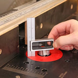Hand using precision height gauge to set router bit depth on woodworking router table