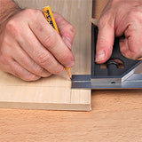Hand using a carpenter's square to mark a straight line on wood for woodworking precision.