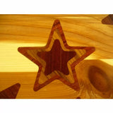 Close-up of wooden star inlay on a polished wood surface, showcasing fine woodworking detail.