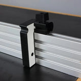 Aluminum router fence with black plastic stop block for woodworking precision.