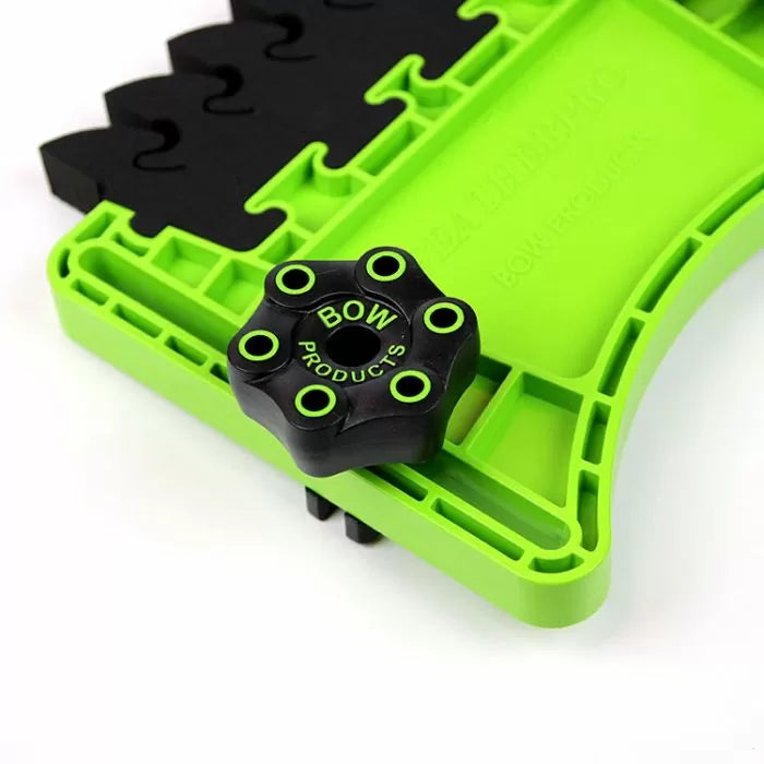 Green plastic woodworking featherboard with adjustable black knob for router tables