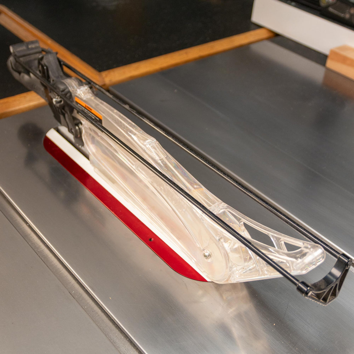 Clear blade guard and red zero-clearance insert installed on a table saw