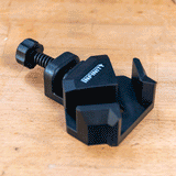 Corner clamp with screw mechanism on workbench for woodworking precision