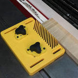 Yellow magnetic featherboard holding wood against table saw fence for precise cutting
