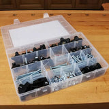 Woodworking jig hardware kit in clear organizer box on workbench