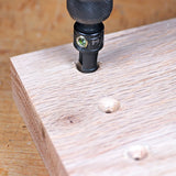 Countersink drill bit creating screw hole in wooden board for woodworking