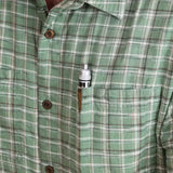 Precision woodworking marking tool clipped in the pocket of a green plaid shirt