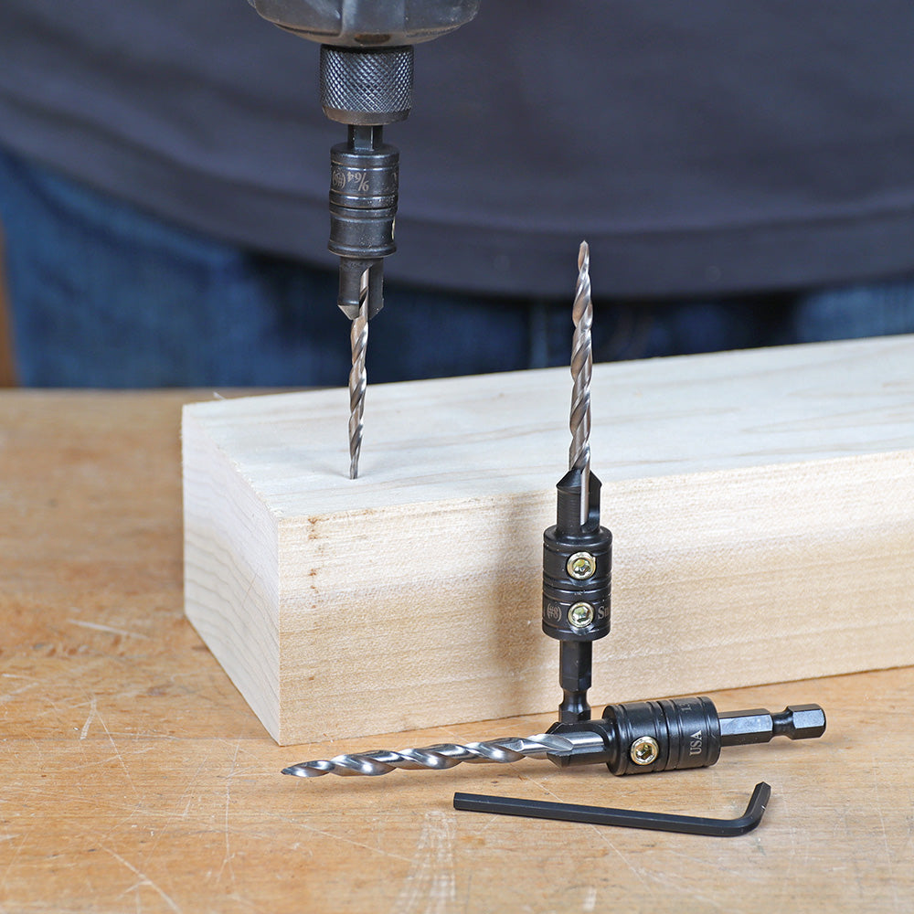 Woodworking countersink drill bits and hex key on wood block and workbench