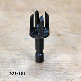 Black woodworking drill bit with hex shank on wood surface, product code 101-101.