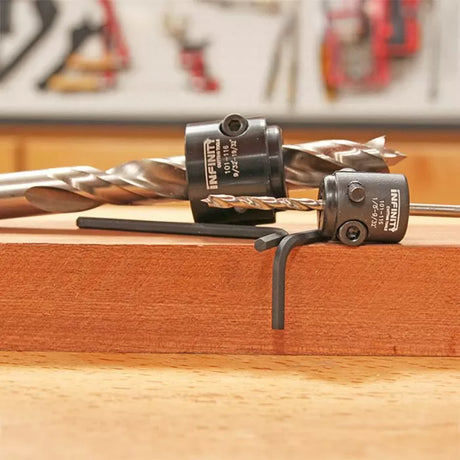 Woodworking drill bits with depth stop collars and hex key on a wooden board