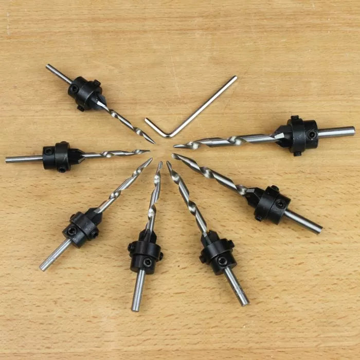 Set of woodworking countersink drill bits with hex key on wooden surface