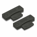 Two black plastic woodworking joiner biscuits with D&C marking for panel alignment