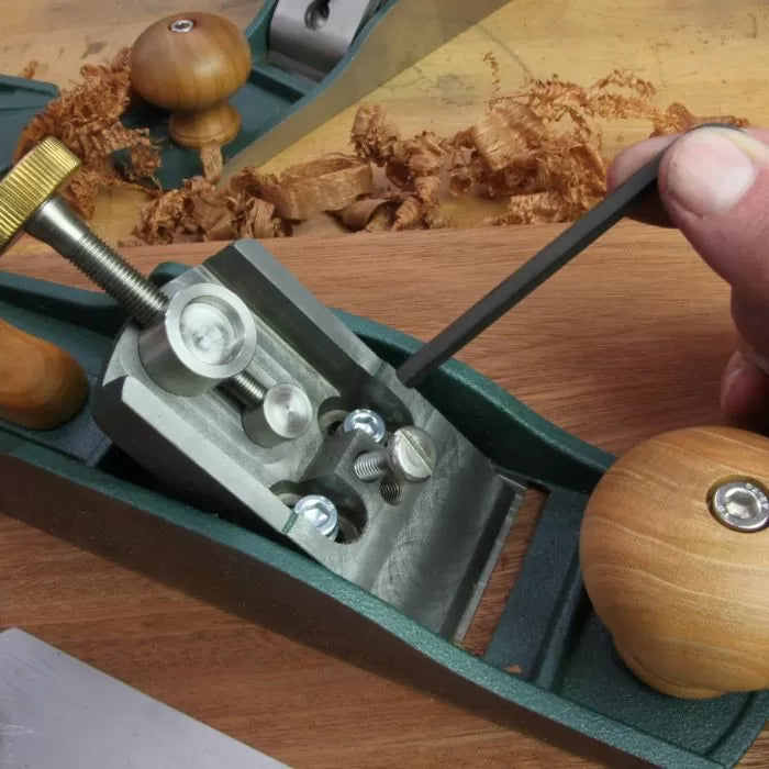 Adjusting frog screws with hex key on woodworking hand plane tool