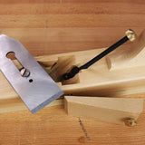 Wood hand plane disassembled on workbench, showcasing blade and beechwood body for woodworking