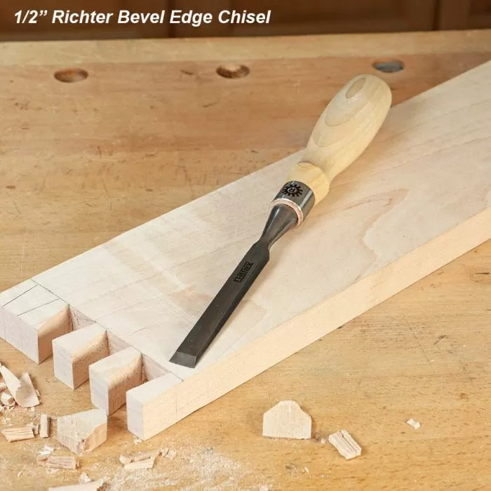 Half-inch bevel edge chisel with wooden handle on a woodworking bench and dovetail joints.