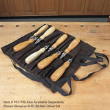 8-piece woodworking chisel set with wooden handles in a black tool roll on a workbench